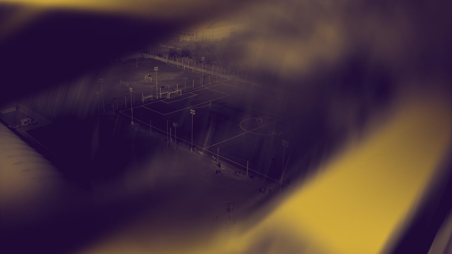 Charge Festival sports fields lit in the festival's gold and purple colours